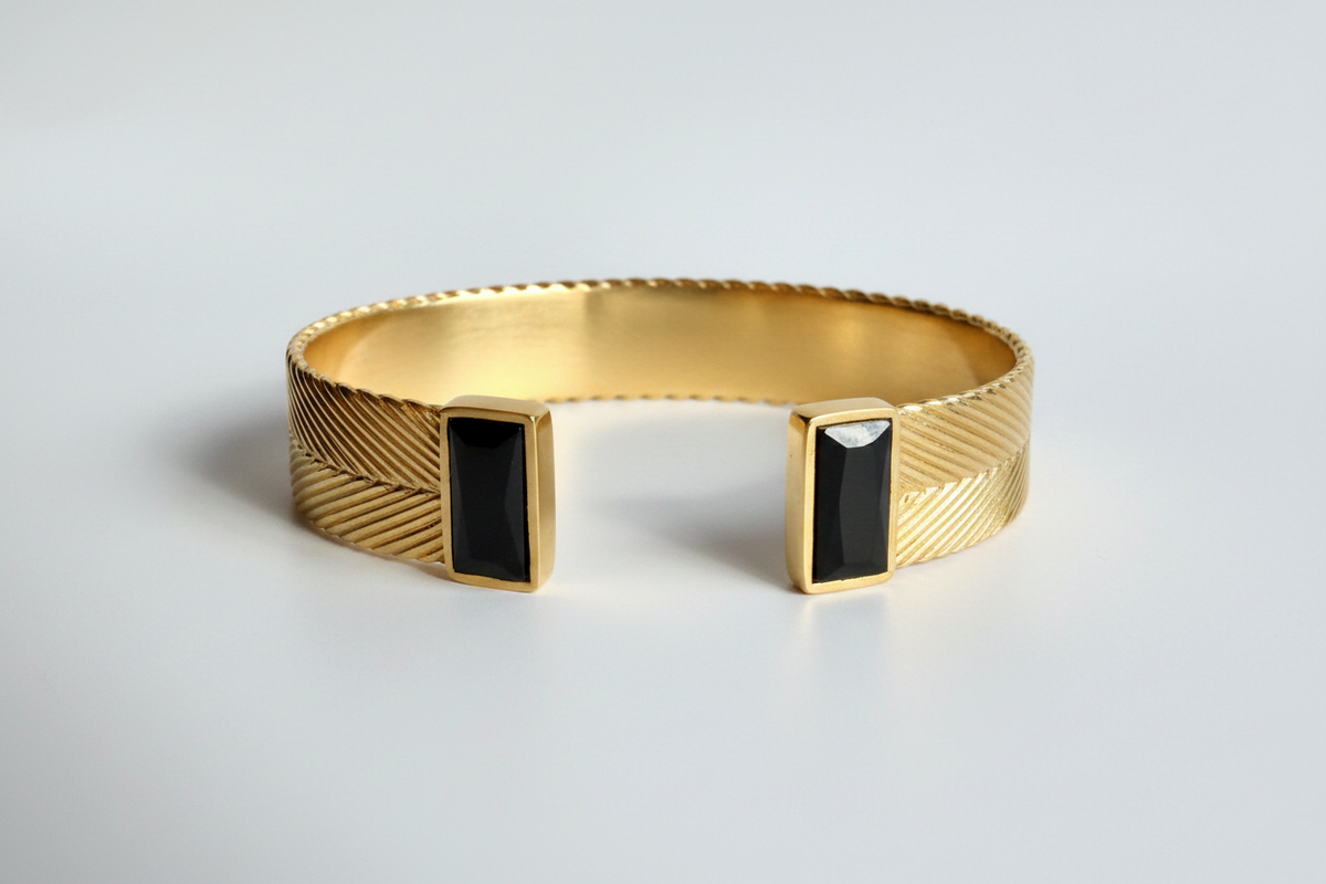 Aphrodite cuff bracelet in gold vermeil with handwoven texture and two rectangular black spinel stones at open ends