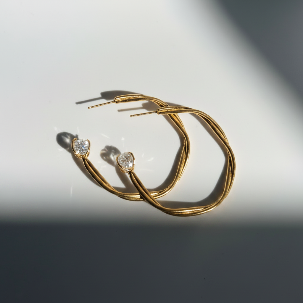 Astraea Twist Hoop Earrings in gold vermeil featuring Herkimer diamond gemstones, handcrafted with elegant twisted detailing and inspired by celestial beauty.