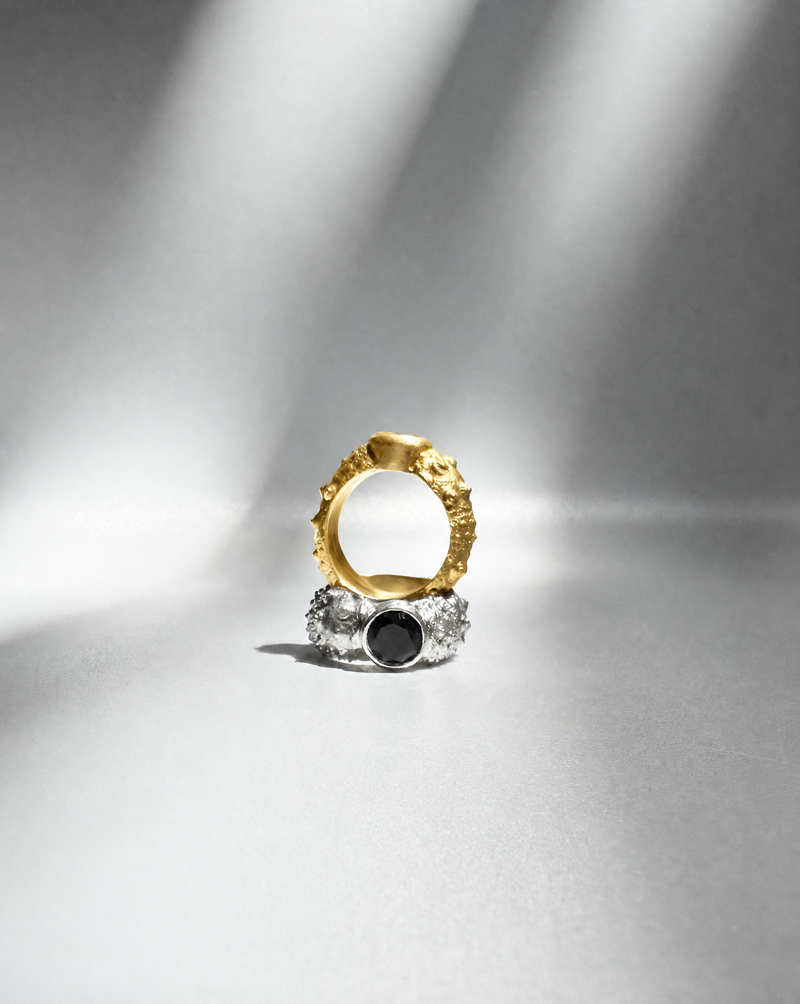 Galene Stone Urchin Rings in gold vermeil and sterling silver, featuring sculptural sea urchin-inspired designs with faceted gemstone accents, including a black spinel centerpiece, handcrafted in New York City.