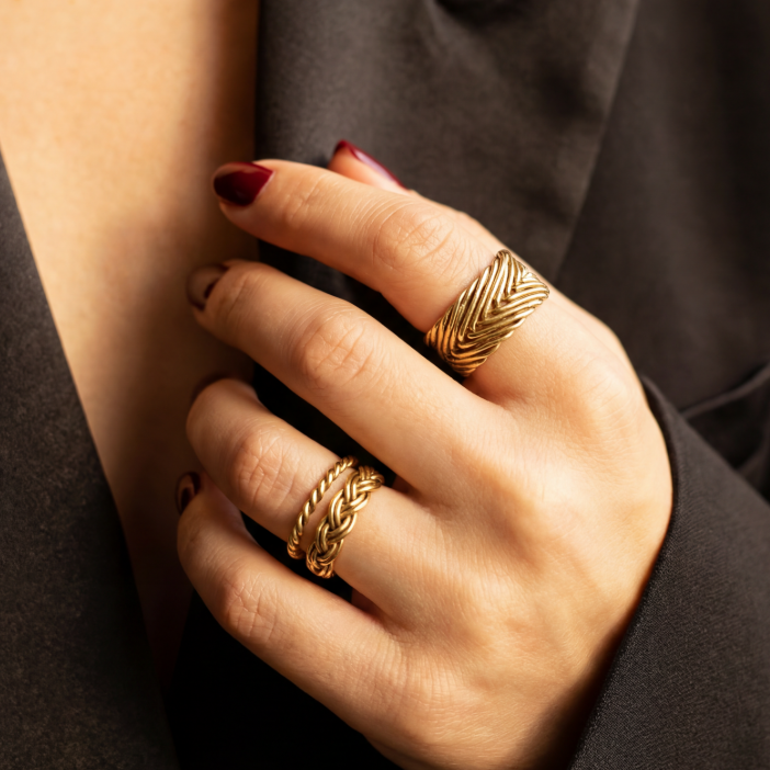 Hand modeling gold vermeil Woven Rings from the Kefi Heritage Collection, showcasing heirloom-inspired textures and handcrafted design details.