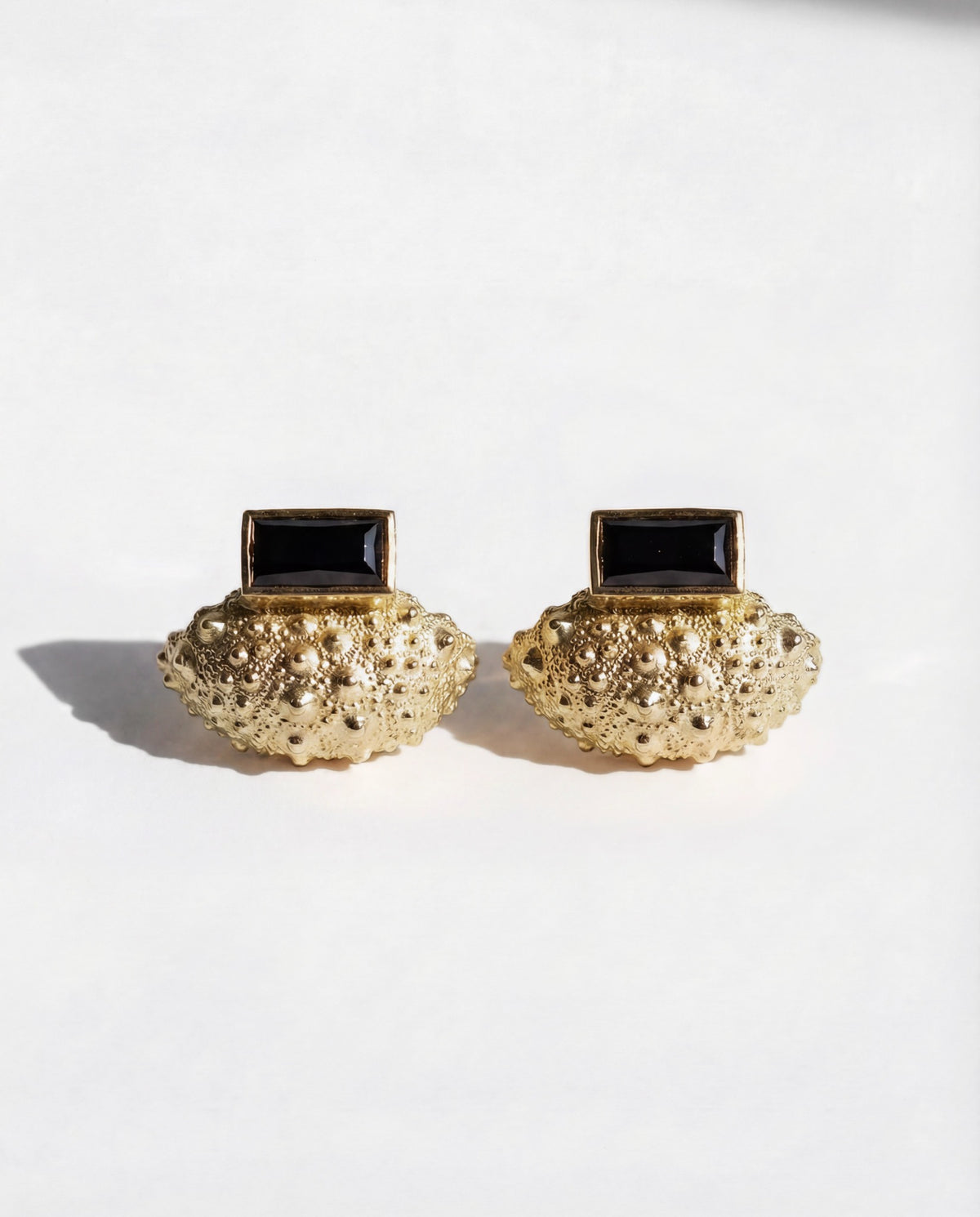 Ceto Urchin Earring Jacket Set in gold vermeil, a sea urchin ear jacket worn behind a black spinel post earring, handcrafted in New York City by Kefi