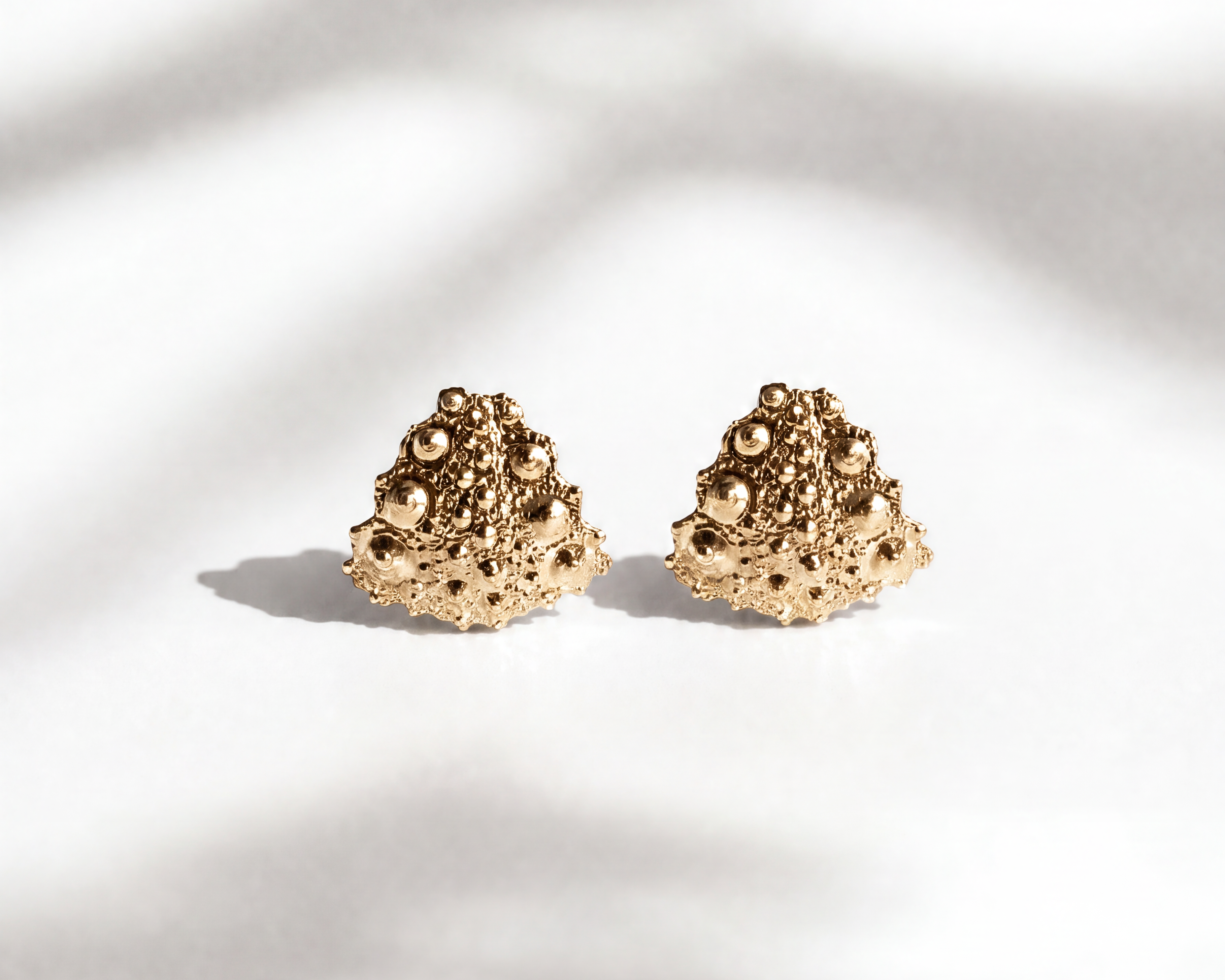 Galatea Tiny Urchin Earrings in 14k gold vermeil featuring a textured sea urchin-inspired design, handcrafted in New York by Kefi.