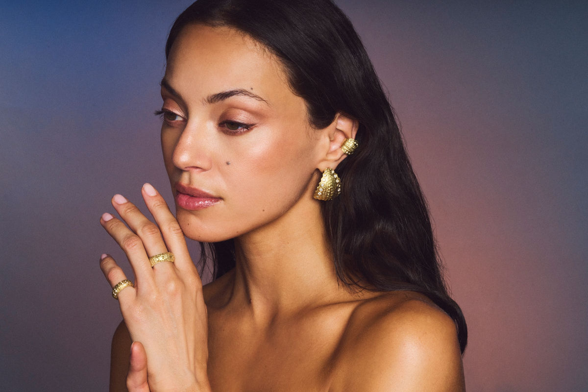 Model wearing Galatea Urchin earrings and rings in gold vermeil with diamonds
