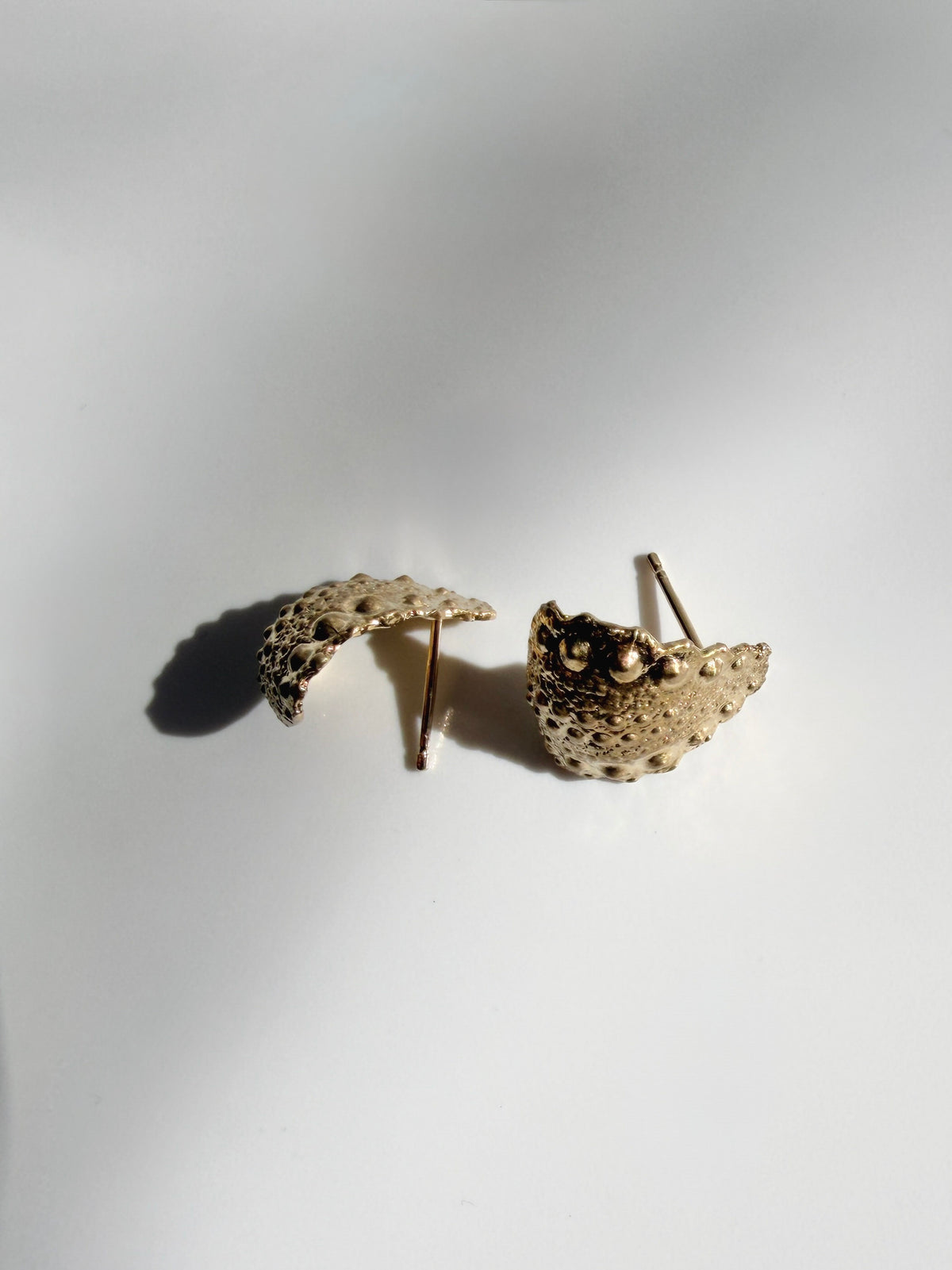 Side view of Galatea Urchin Hug Earrings in gold vermeil showing the curved form that wraps the earlobe