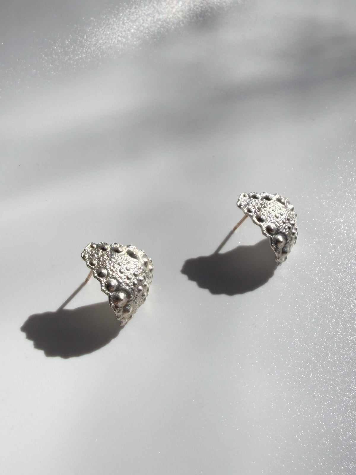 Pair of Galatea Urchin Hug Earrings in sterling silver showing the preserved sea urchin texture