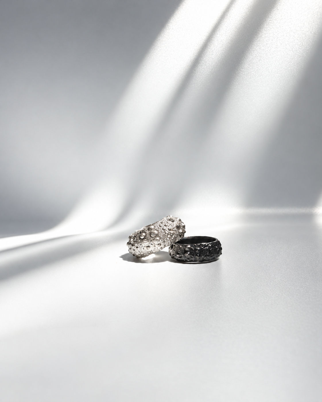 Galene Urchin Bold Ring in sterling silver beside a narrow Galene Urchin Ring in oxidized sterling silver