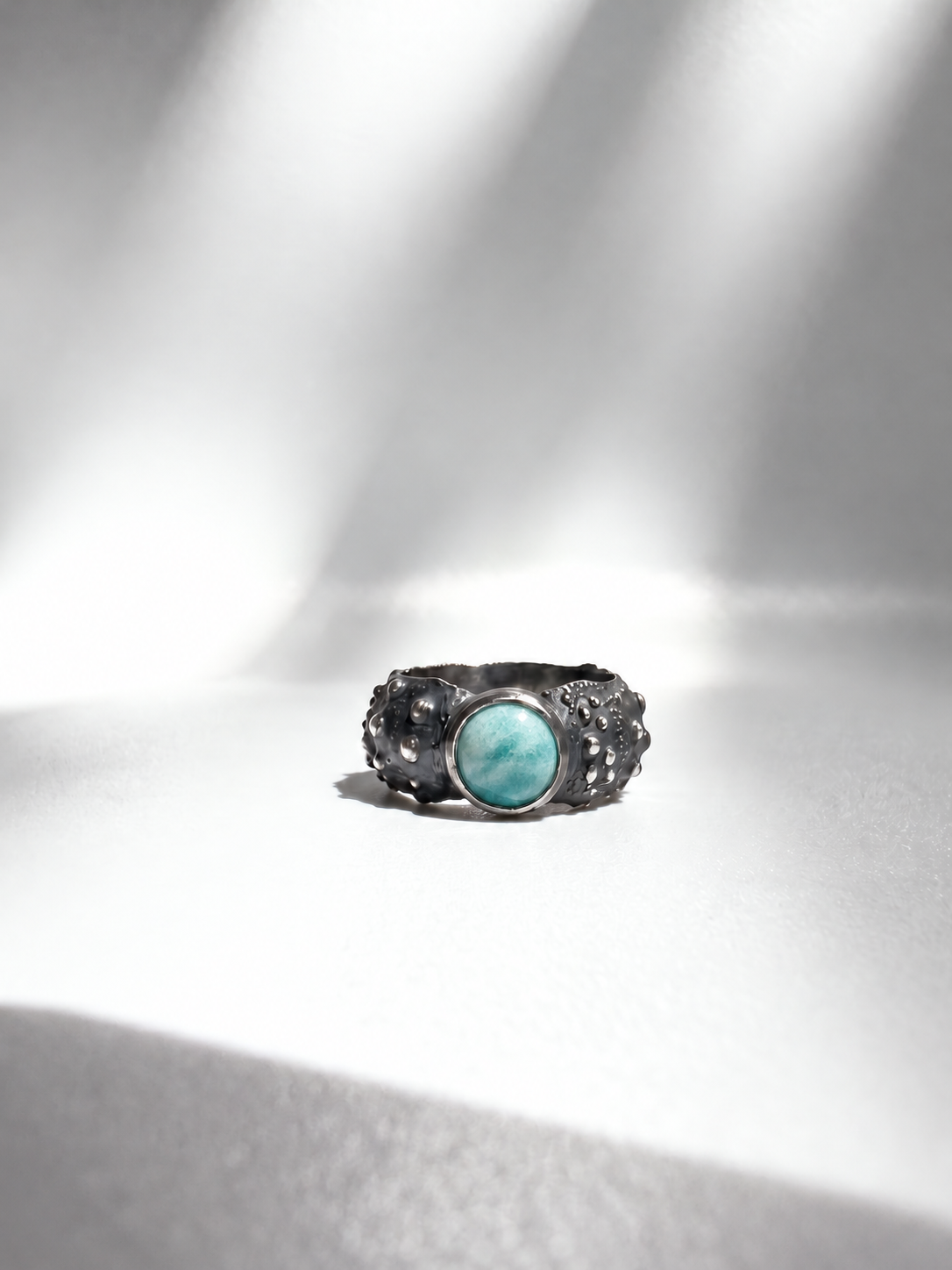 Galene Urchin Stone Ring in oxidized sterling silver with a bezel-set amazonite stone, cast from a sea urchin shell.