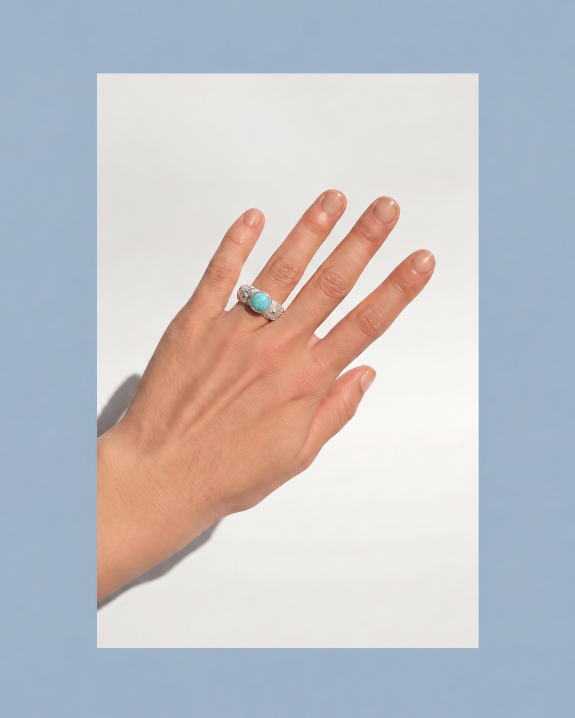 Hand wearing the Galene Urchin Stone Ring in sterling silver with a bezel-set amazonite stone.