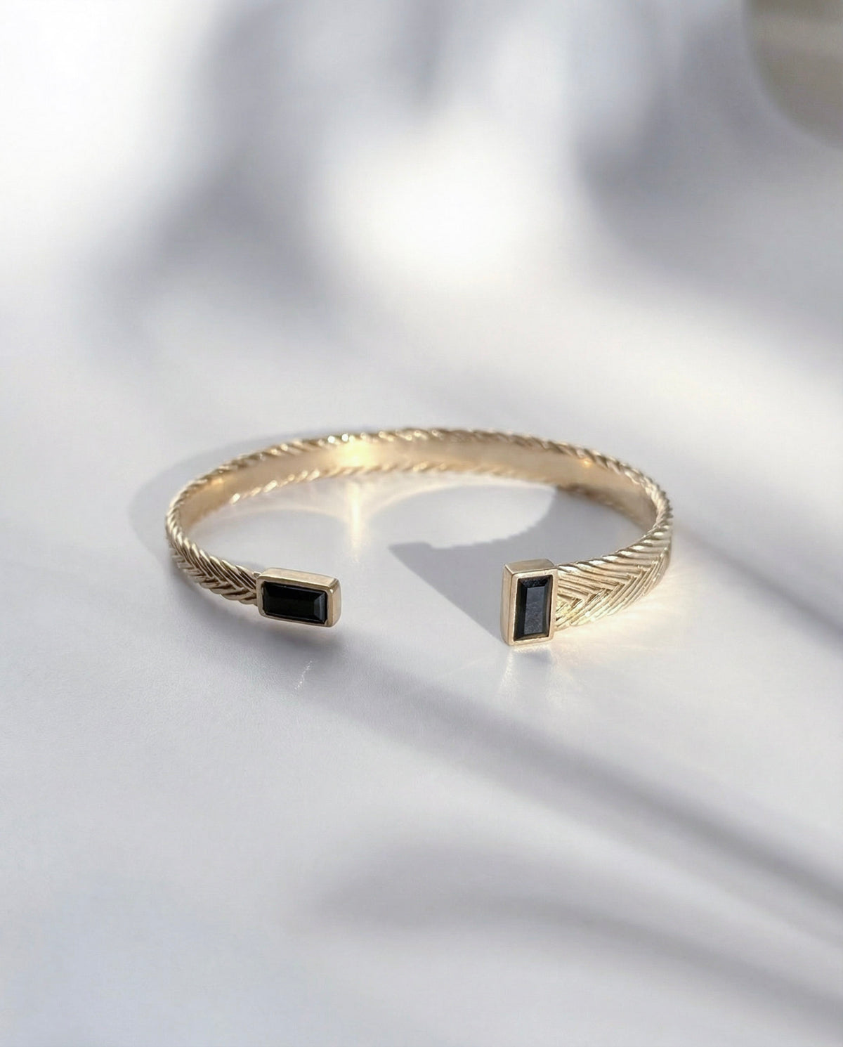 Hestia Woven Cuff in gold vermeil with handwoven detail and black spinel stones, handcrafted in New York City by Kefi