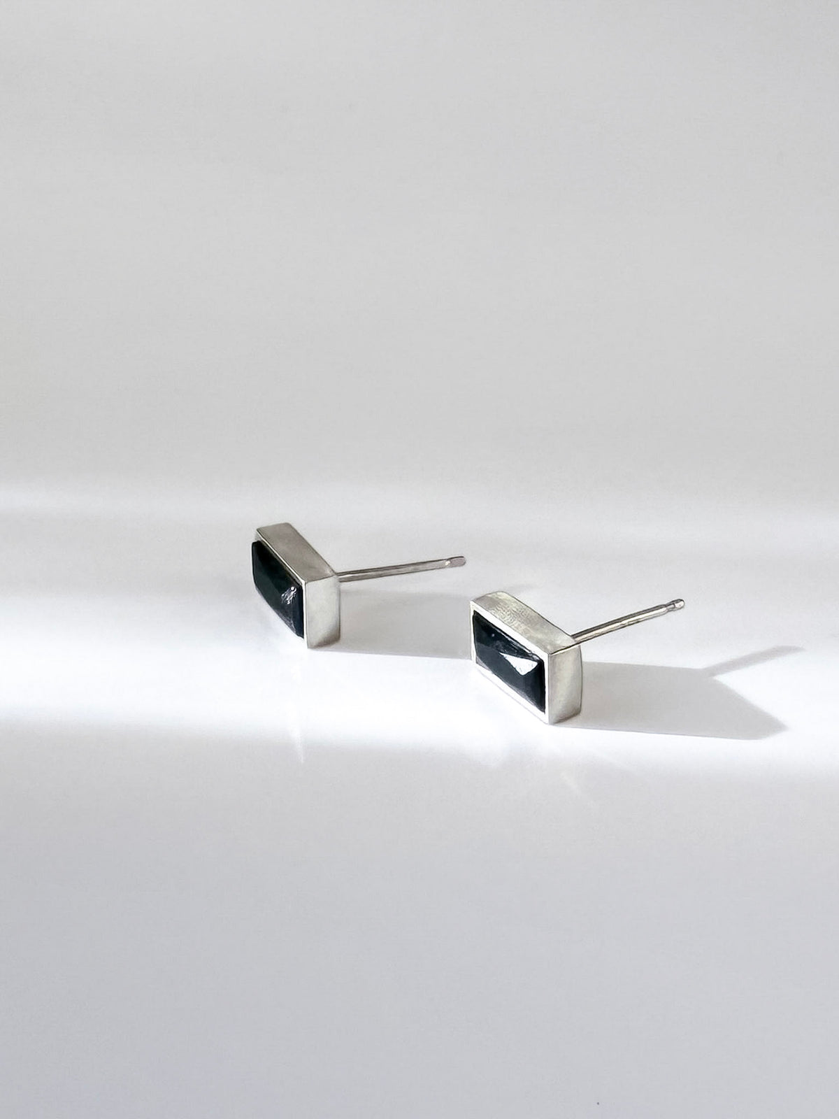 Spinel Post Earrings in sterling silver set with rectangular natural black spinel, a sculptural stud that pairs with Kefi earring jackets