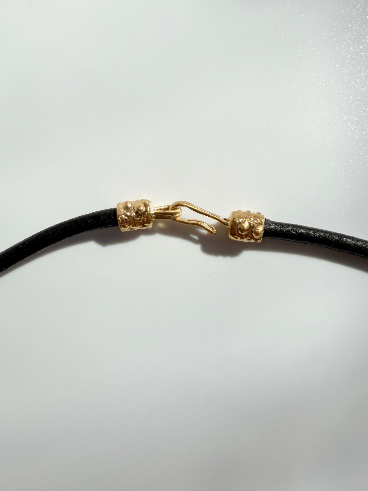 Gold vermeil hook clasp on the black leather cord of the Thalassa Urchin Necklace