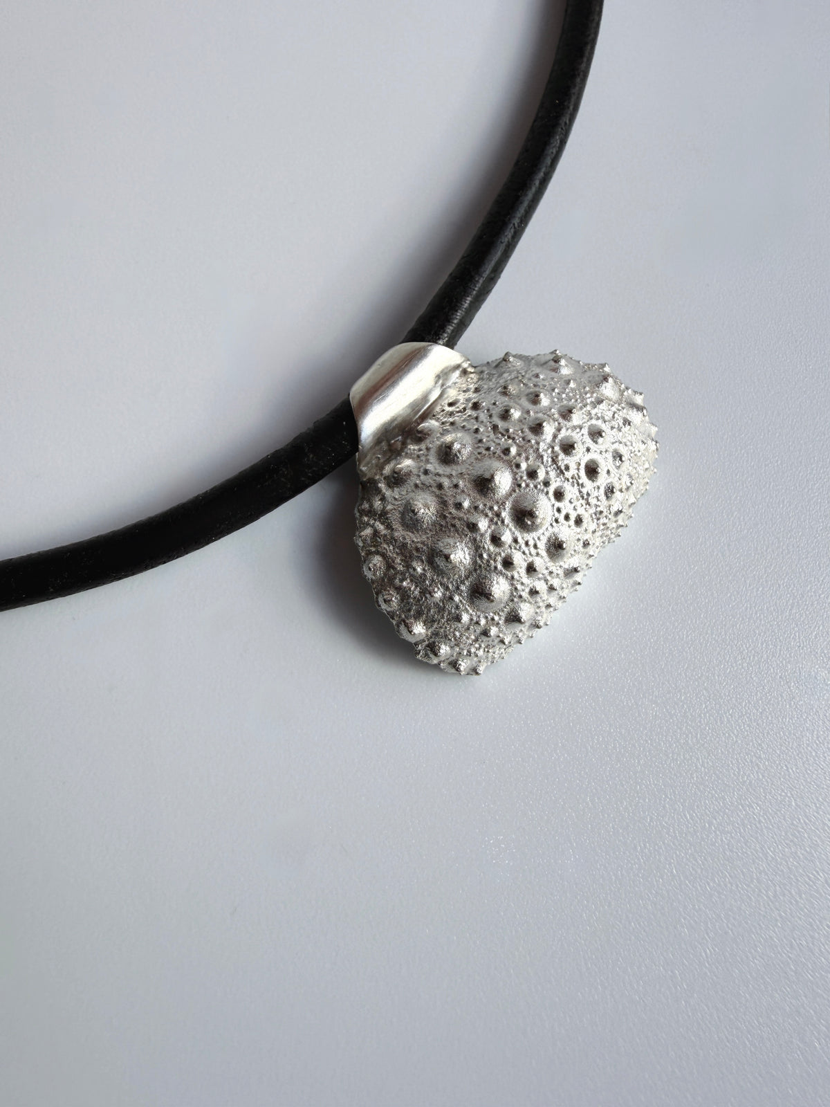 Thalassa Urchin Necklace in sterling silver on a black leather cord