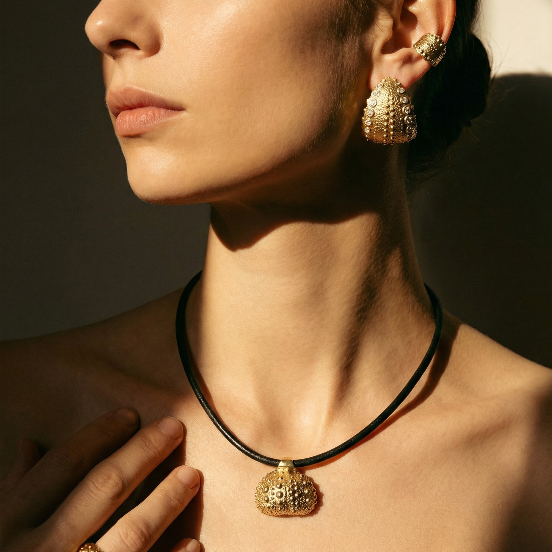 Model wearing gold vermeil jewelry from the Kefi Urchin Collection, showcasing sculptural rings, earrings, and necklaces inspired by the textures and forms of sea urchins and handcrafted in New York City.