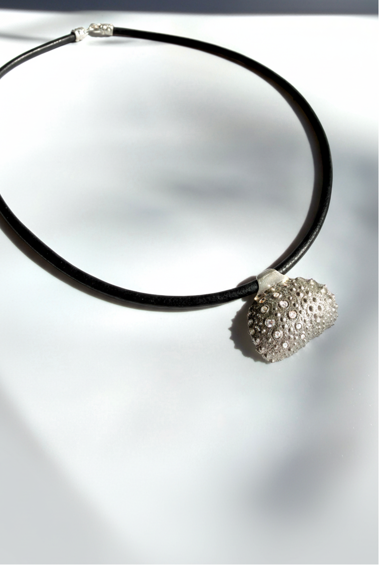 Thalassa Urchin Necklace in sterling silver featuring diamond accents and a leather cord, inspired by the organic textures of sea urchins and handcrafted in New York City.