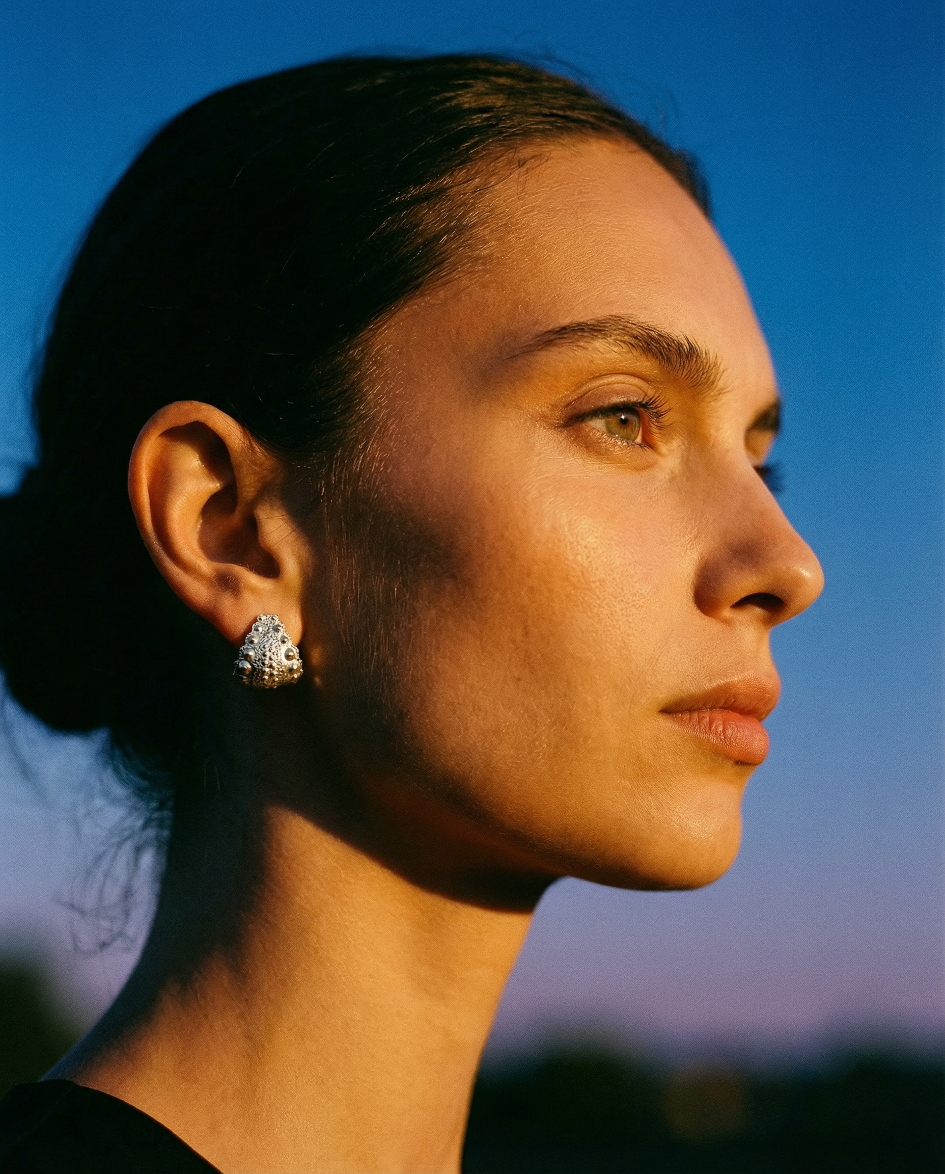 Model wearing Urchin Hug Earrings in sterling silver, demonstrating natural sea urchin texture and organic form