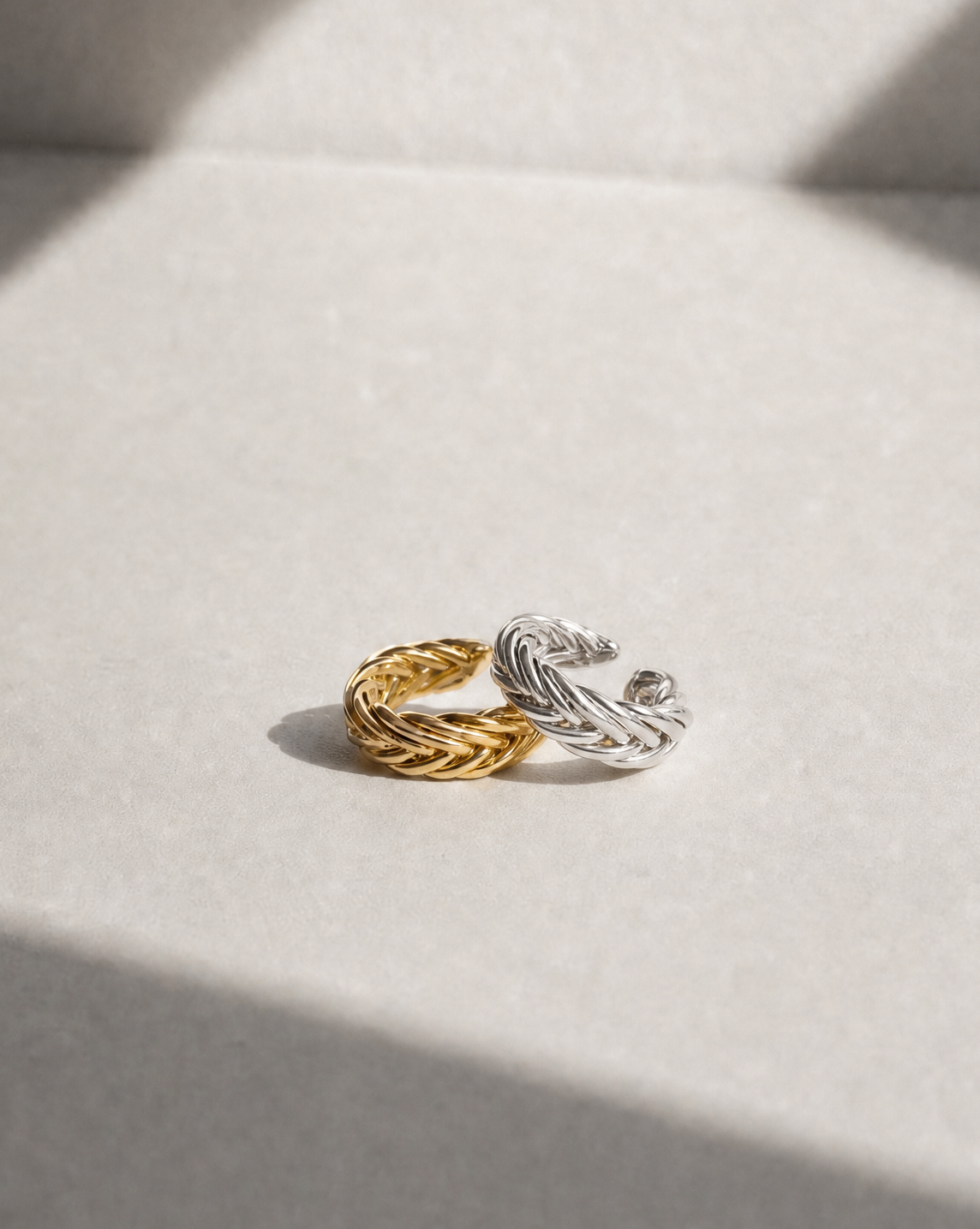 Product photo of the Penelope Woven Ear Cuff in sterling silver and gold vermeil, featuring an intricate handwoven texture and sculptural curved shape.