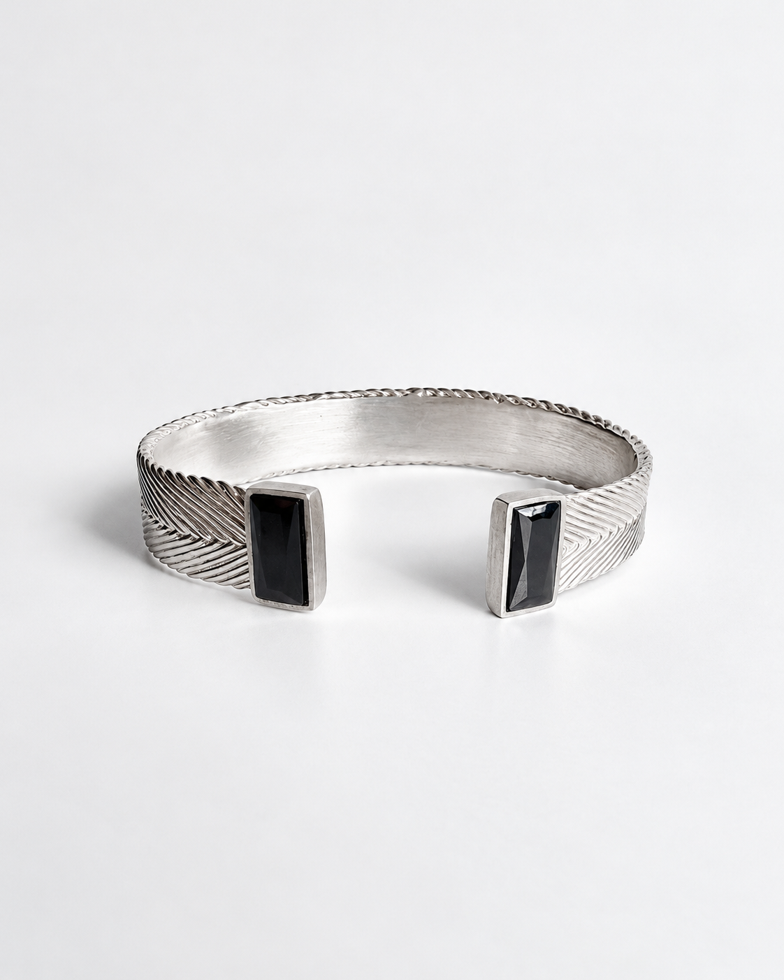 Aphrodite Woven Cuff in sterling silver with handwoven texture and two custom-cut rectangular black spinel stones at the open ends