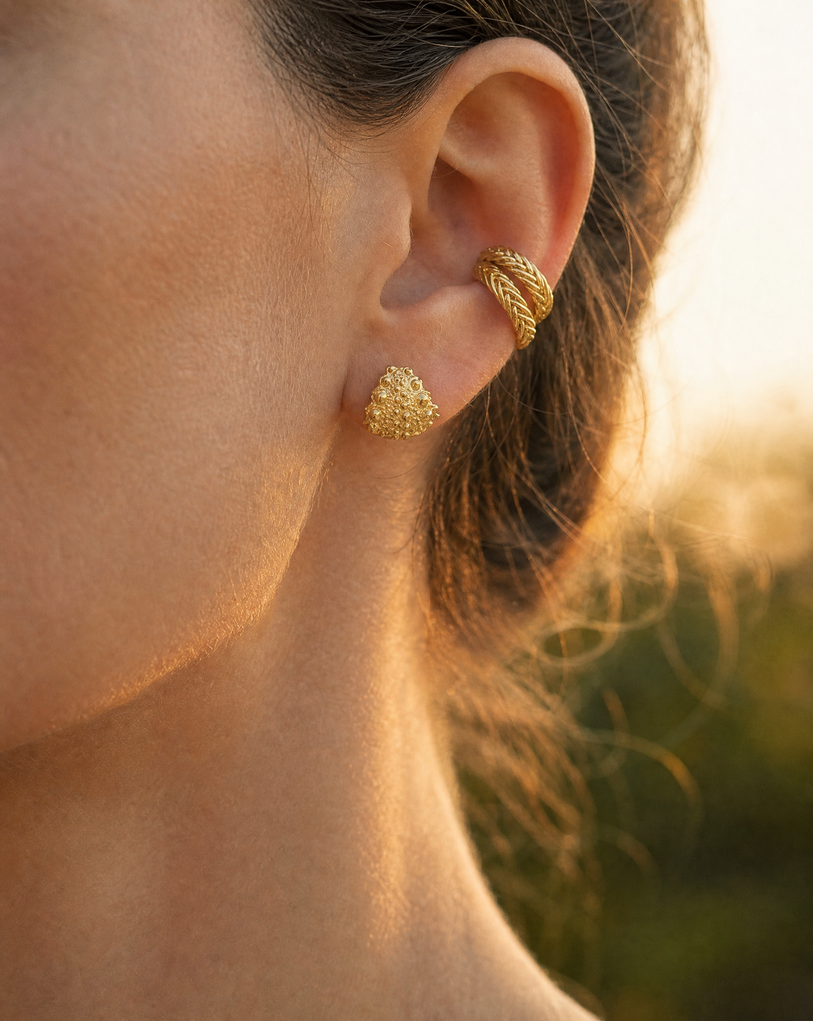 Galatea Tiny Urchin Earrings in 14k gold vermeil featuring a textured sea urchin-inspired design, handcrafted in New York by Kefi. On model.
