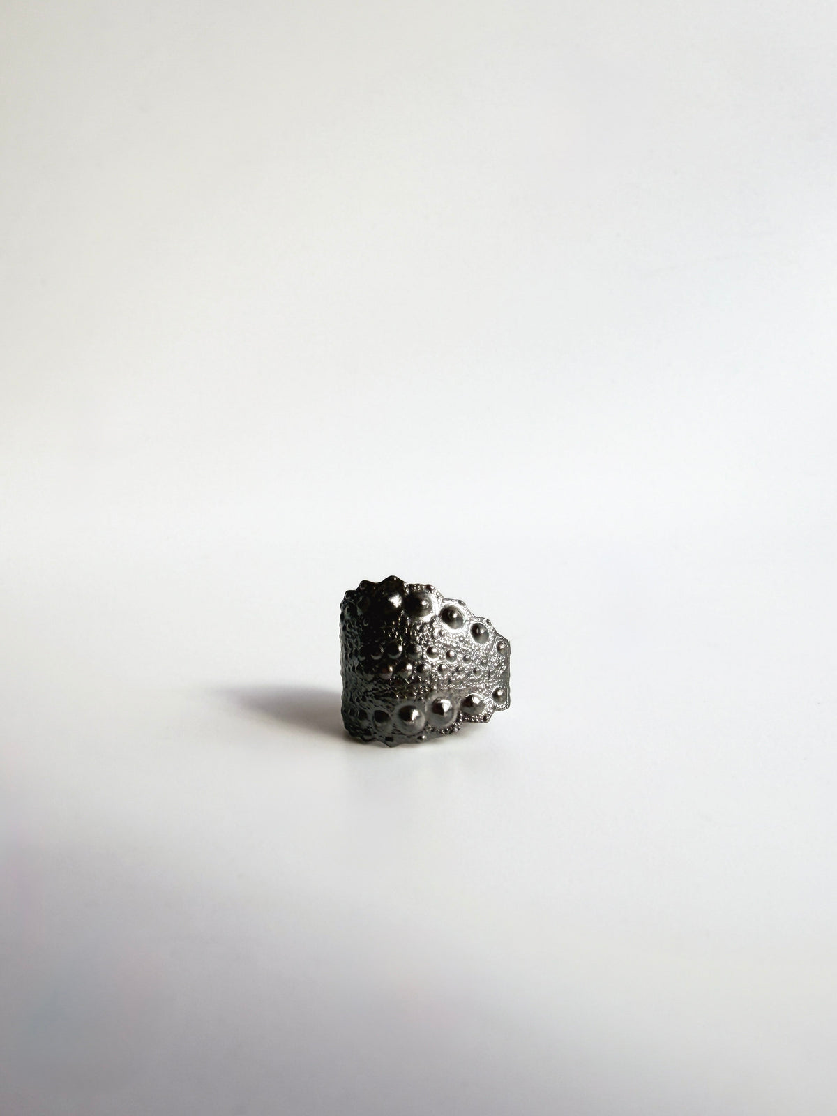 Galatea Urchin Ear Cuff in oxidized sterling silver, the darkened finish deepening the sea urchin texture