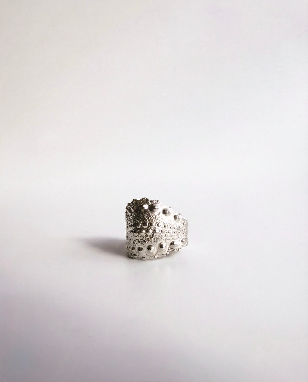 Galatea Urchin Ear Cuff in sterling silver, cast from a sea urchin shell with its natural ridges preserved, handcrafted in New York City by Kefi