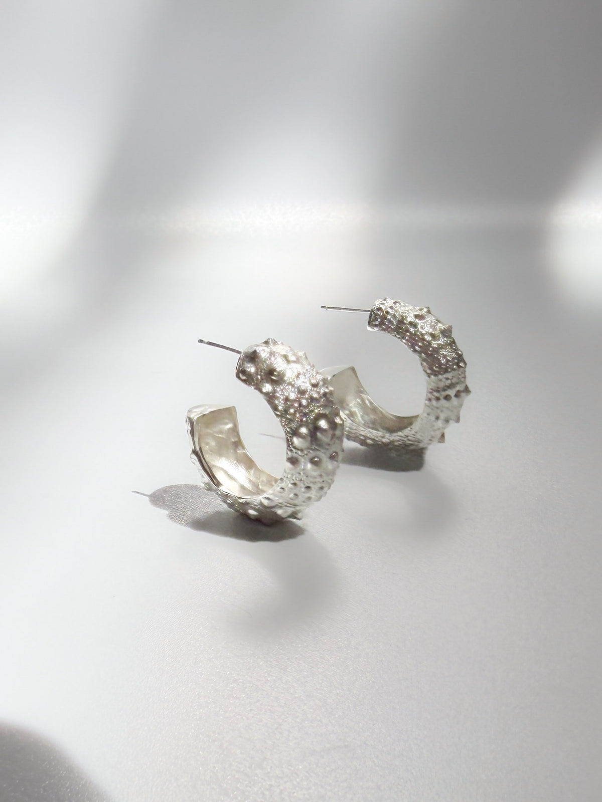 Galatea Urchin Hoops in sterling silver, hoop earrings cast from a sea urchin shell, handcrafted in New York City by Kefi