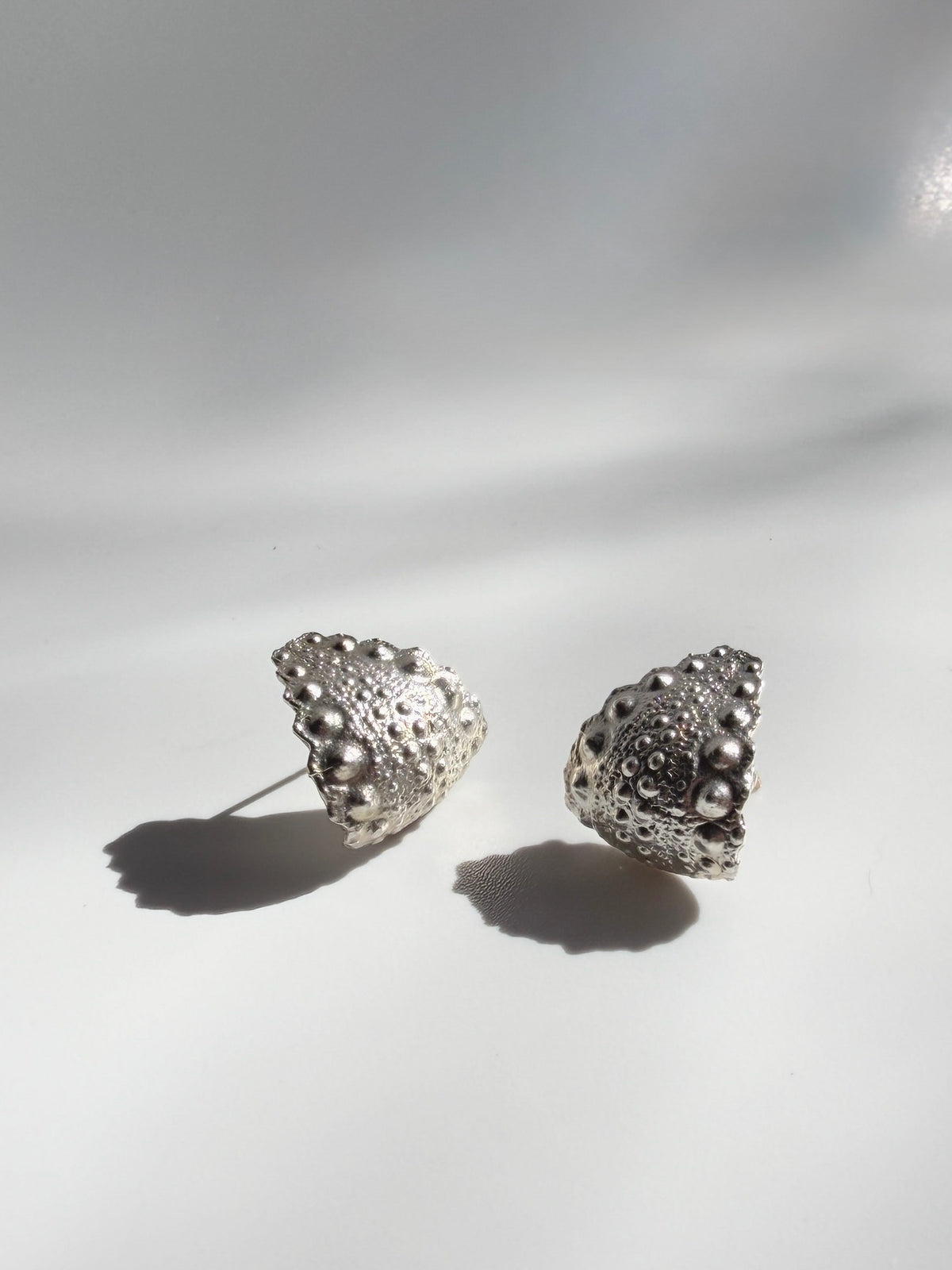 Galatea Urchin Hug Earrings in sterling silver, lightweight earrings cast from a sea urchin shell, handcrafted in New York City by Kefi
