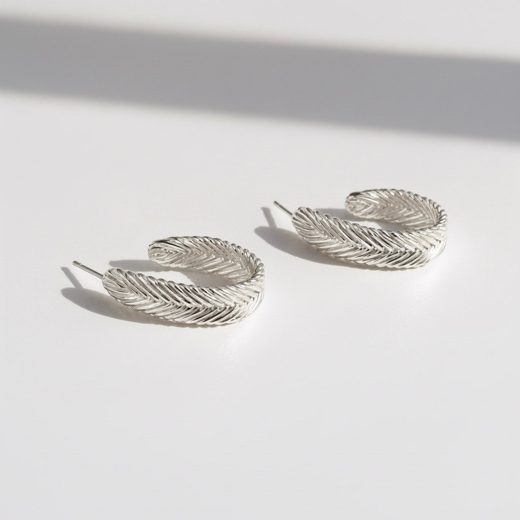 Harmonia Woven Hoop Earrings in sterling silver with handwoven herringbone texture, handcrafted in New York City by Kefi