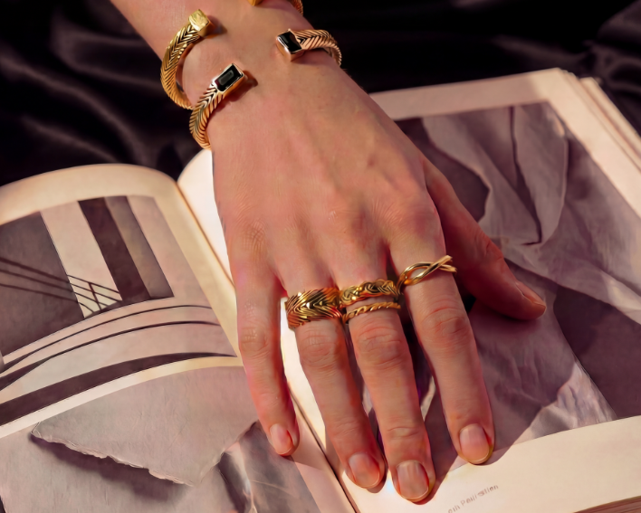 Hand modeling Kefi Heritage Collection rings and bracelets in gold vermeil, showcasing heirloom-inspired designs handcrafted in New York City.