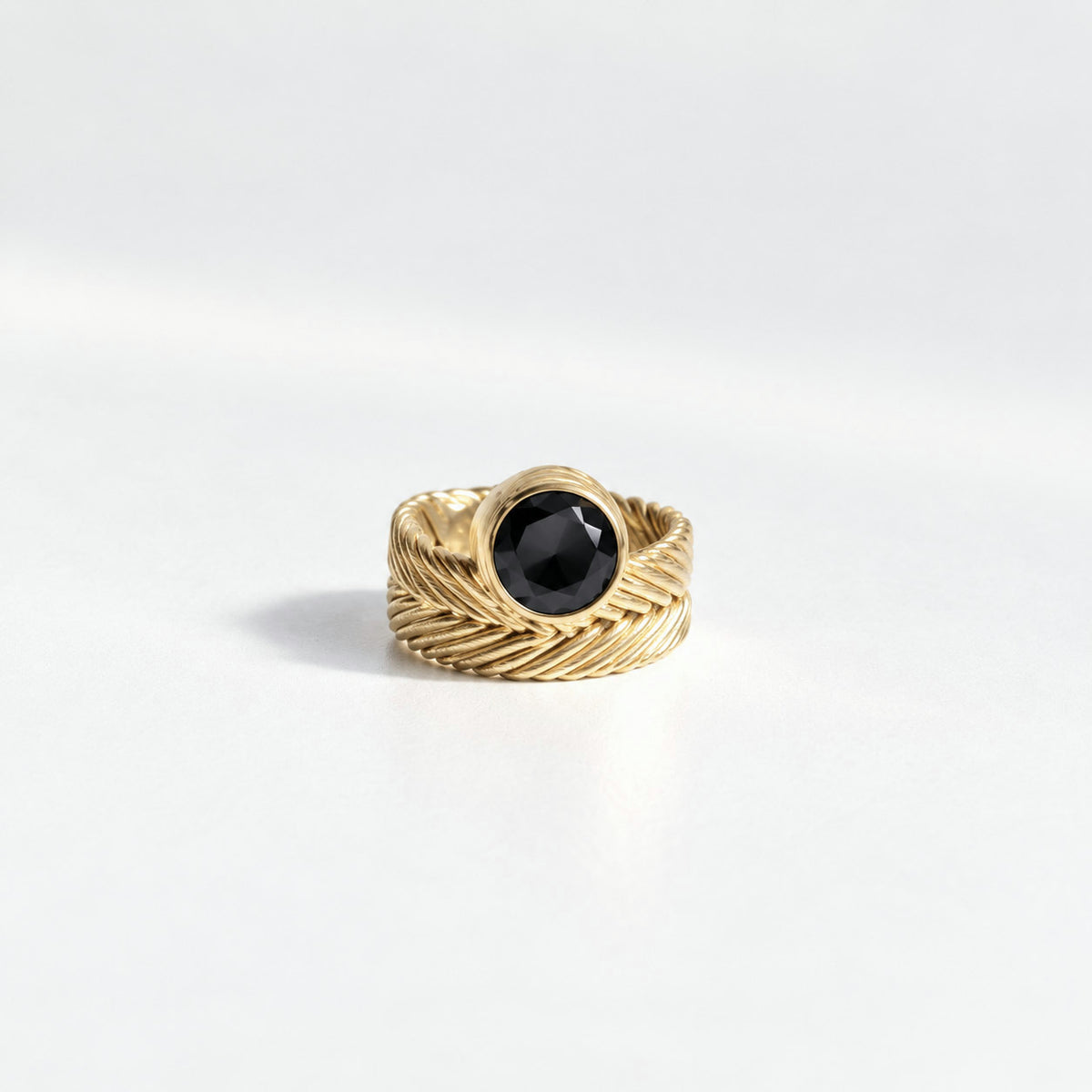 Perched Woven Solitaire Ring in gold vermeil with a round black spinel set above a handwoven band