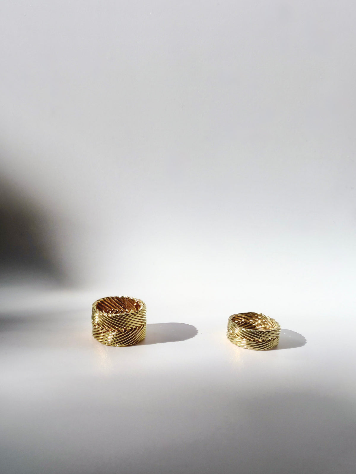 Tall Woven Ring and Woven Ring in gold vermeil side by side, showing two widths of handwoven chevron band