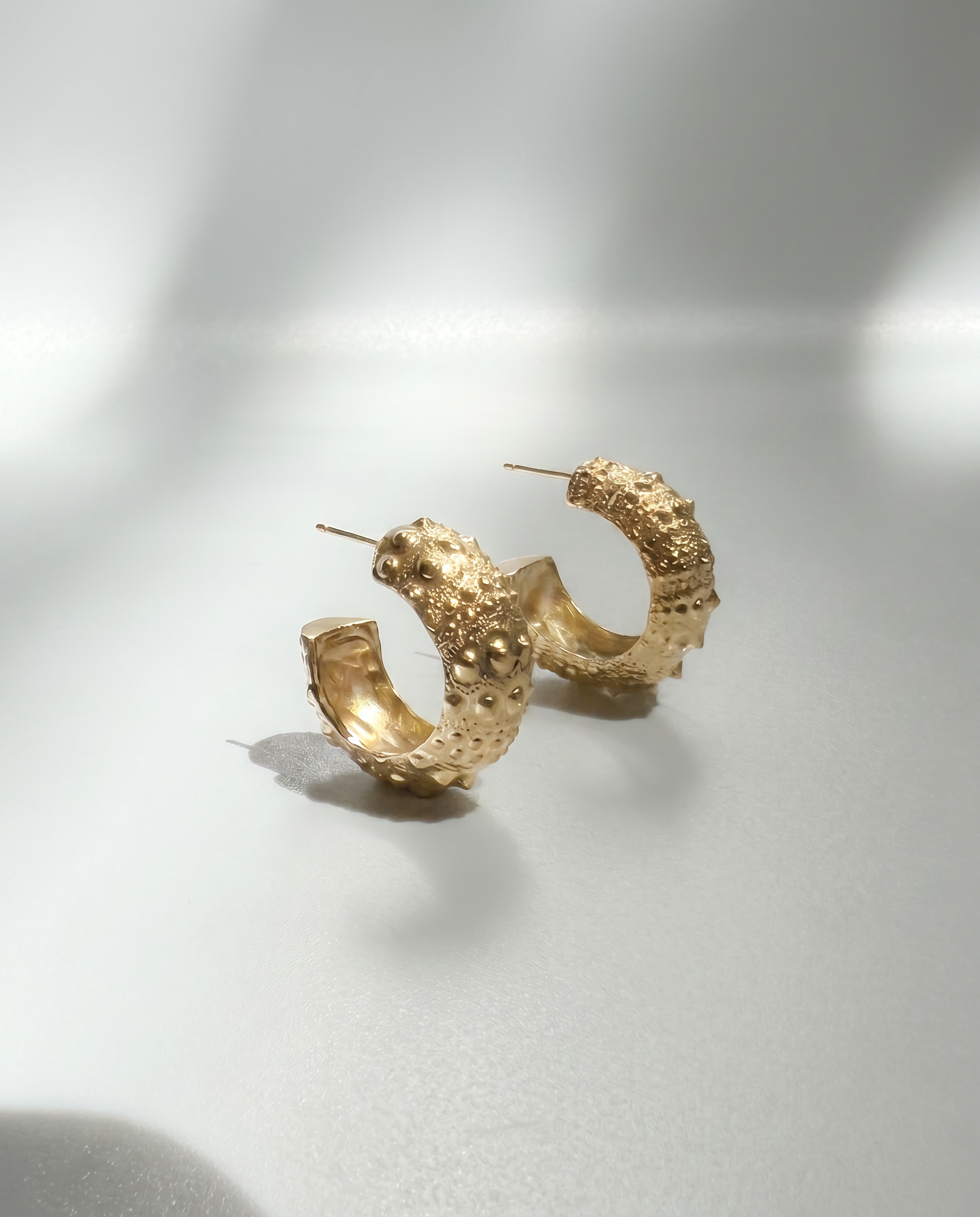 Urchin Hoop Earrings in gold vermeil featuring sculptural sea urchin-inspired textures and an organic coastal design, handcrafted in New York City.