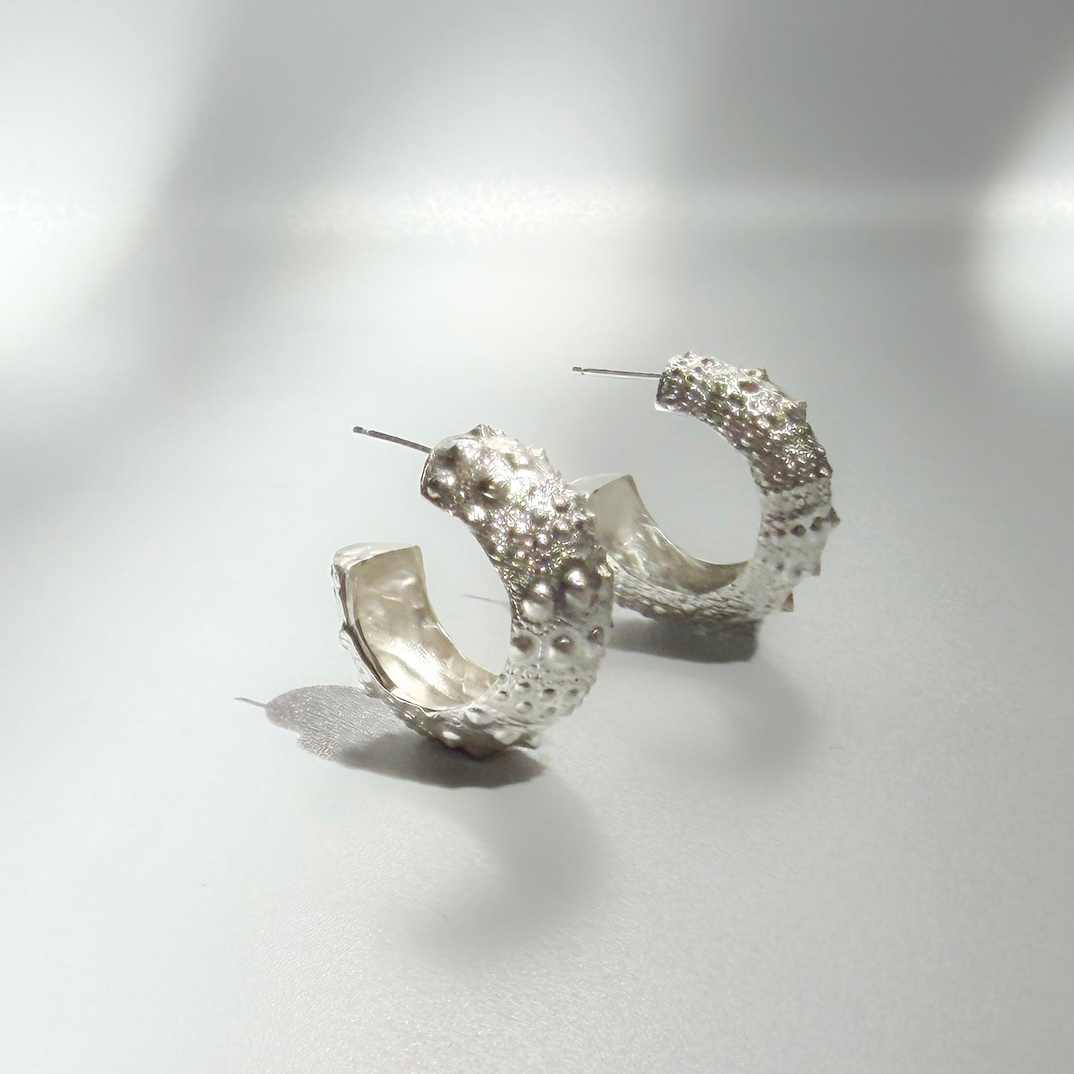 Urchin Hoop Earrings in sterling silver featuring sculptural sea urchin-inspired textures and an organic coastal design, handcrafted in New York City.