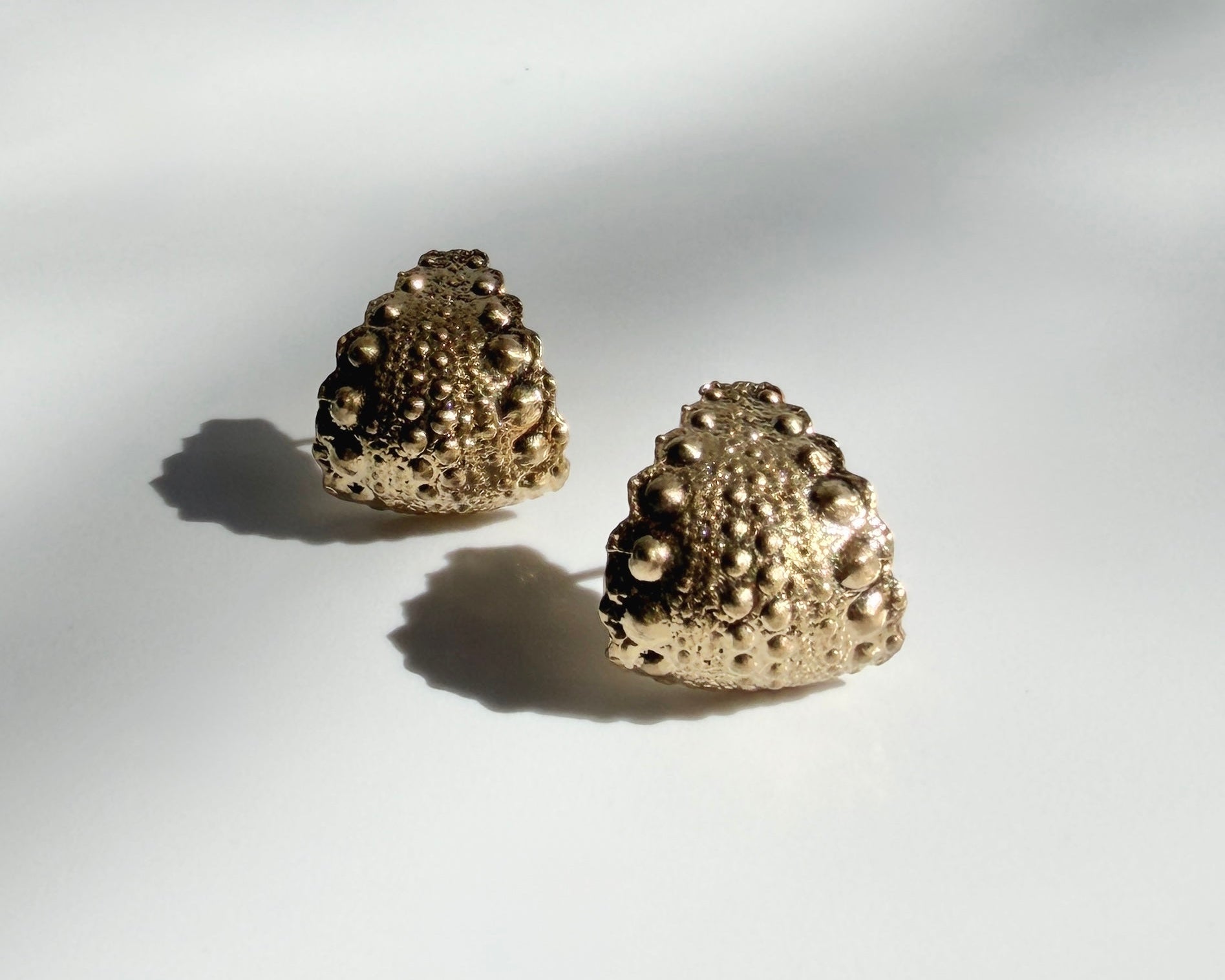 Urchin Hug Earrings in gold vermeil with preserved sea urchin shell texture and sculptural hoop design by Kefi