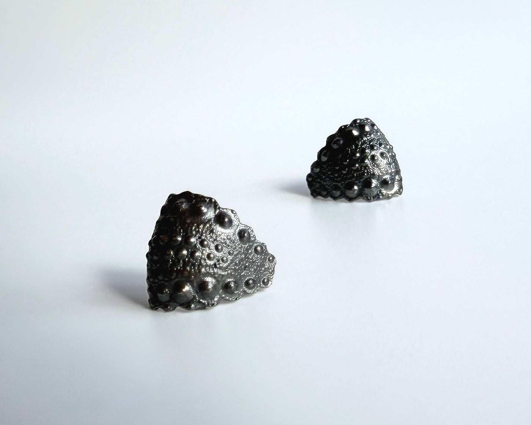 Urchin Hug Earrings in oxidized sterling silver with natural sea urchin texture and organic hoop form