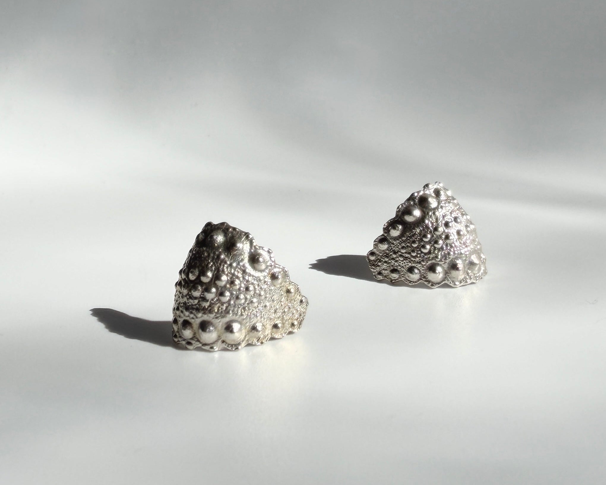 Urchin Hug Earrings in sterling silver with natural sea urchin texture and organic hoop form