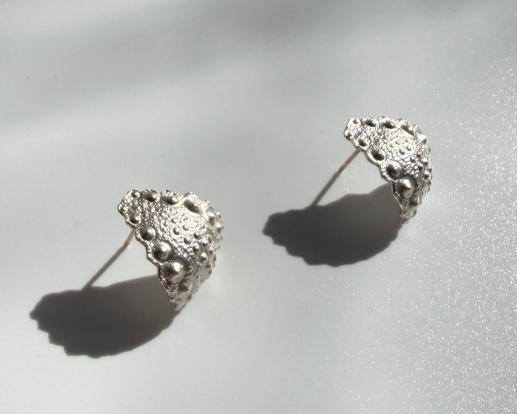 Urchin Hug Earrings in sterling silver with natural sea urchin texture and organic hoop form